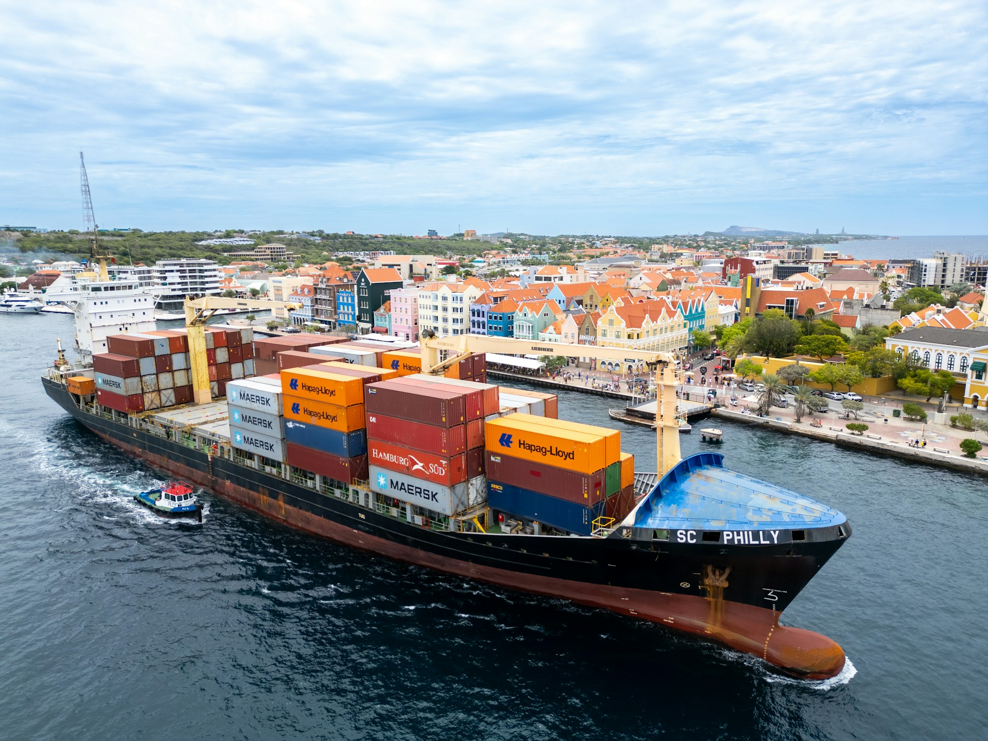 Container ship entering a busy international port