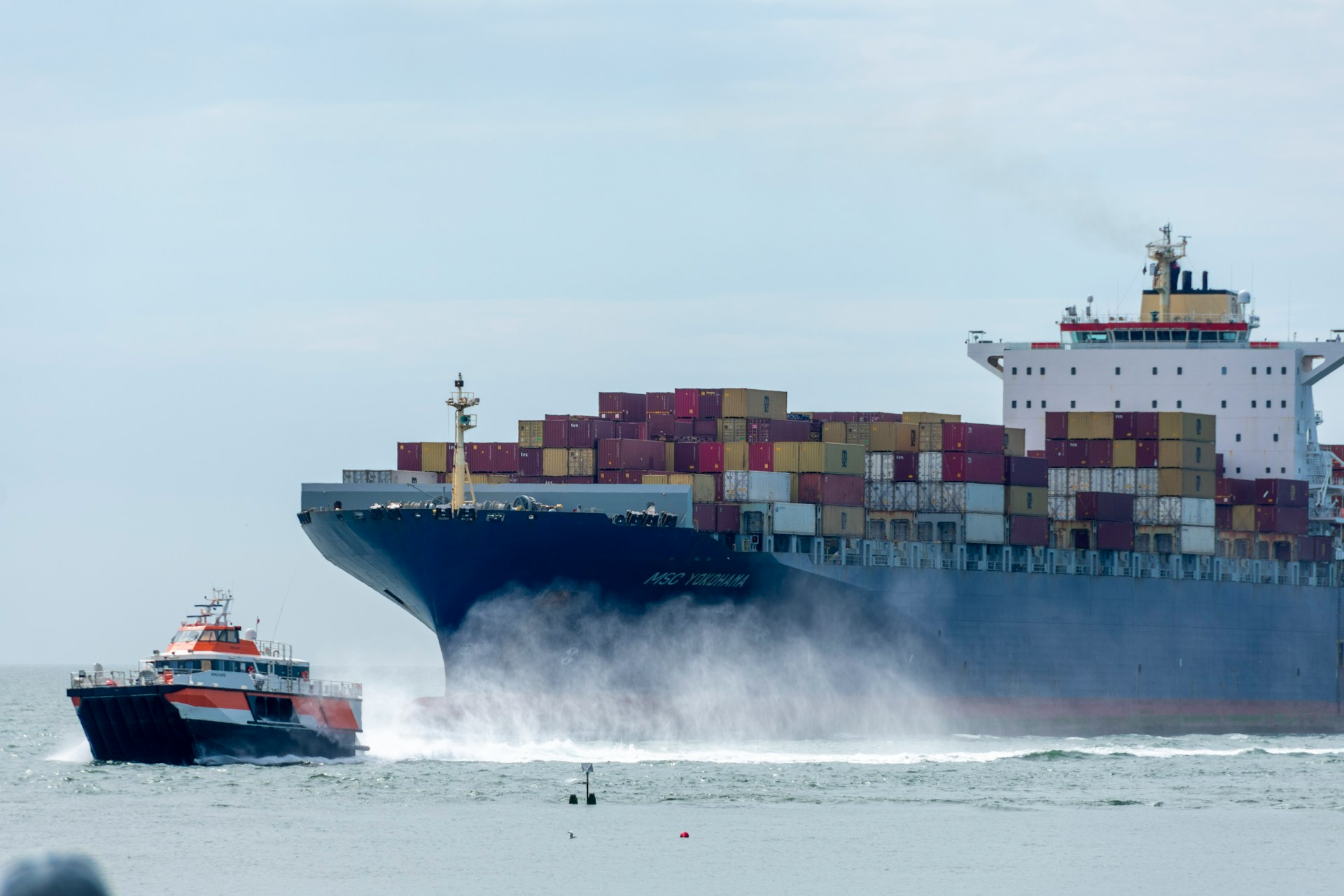Container ship at sea under pilot escort